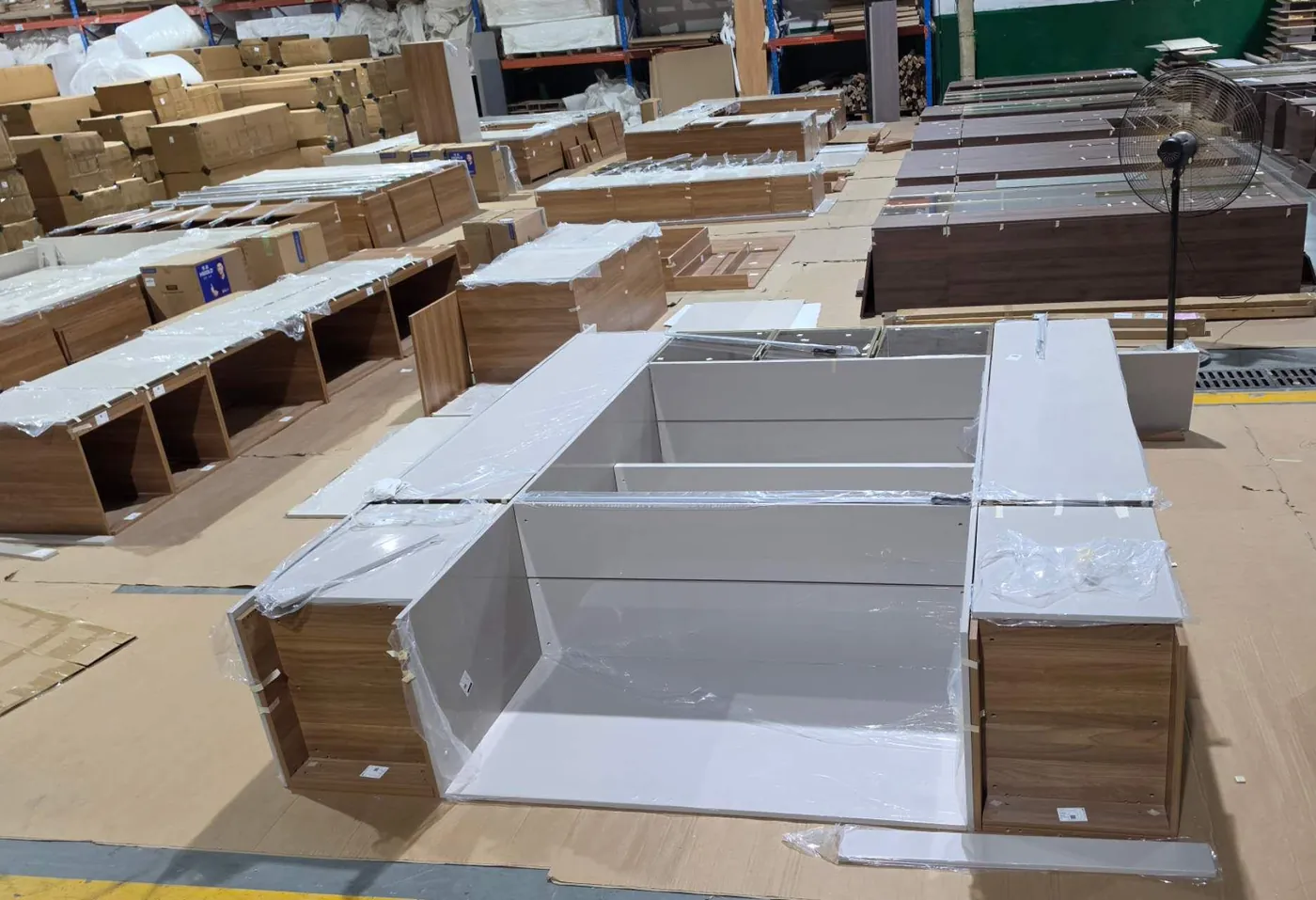 Wrapped kitchen cabinet carcases laid out on the factory floor