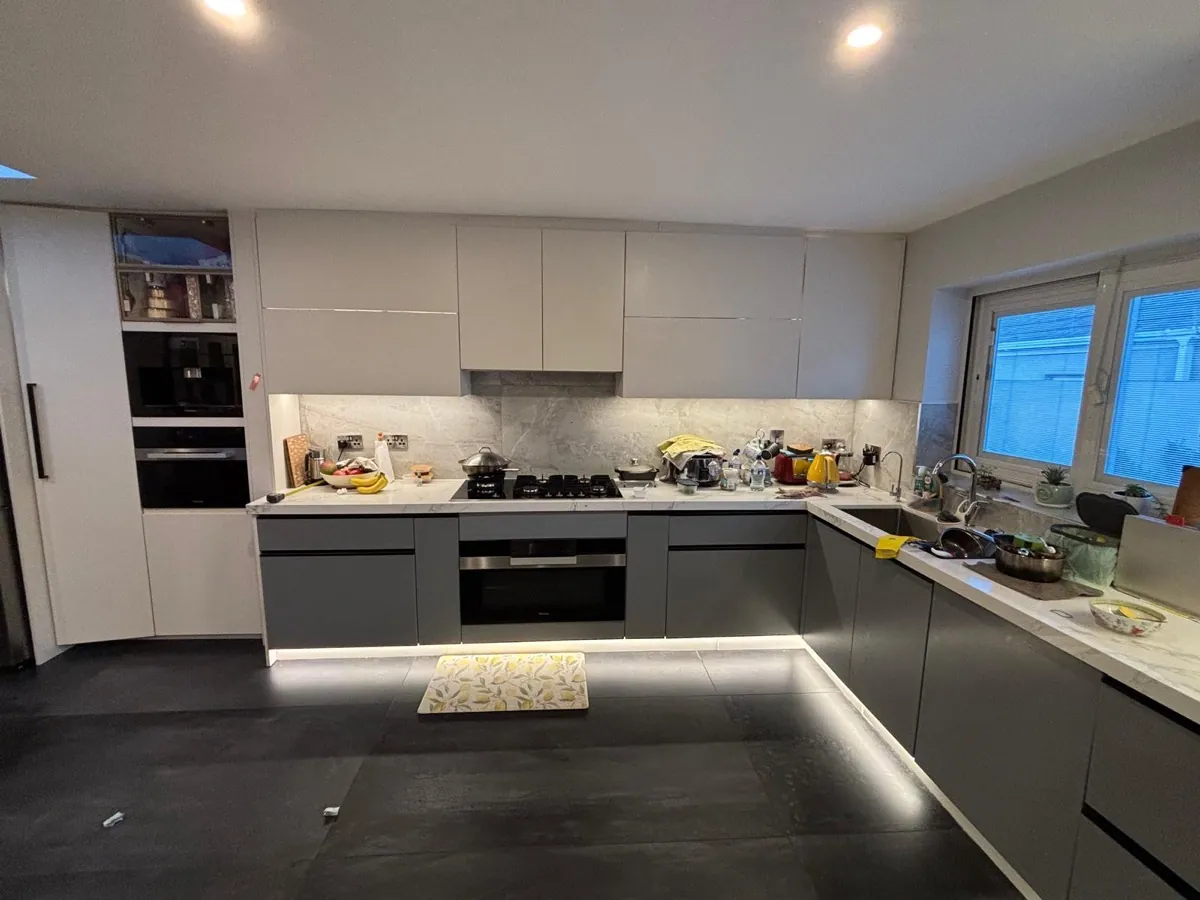 A kitchen we designed and fitted in Dublin, grey handleless units with a marble effect worktop