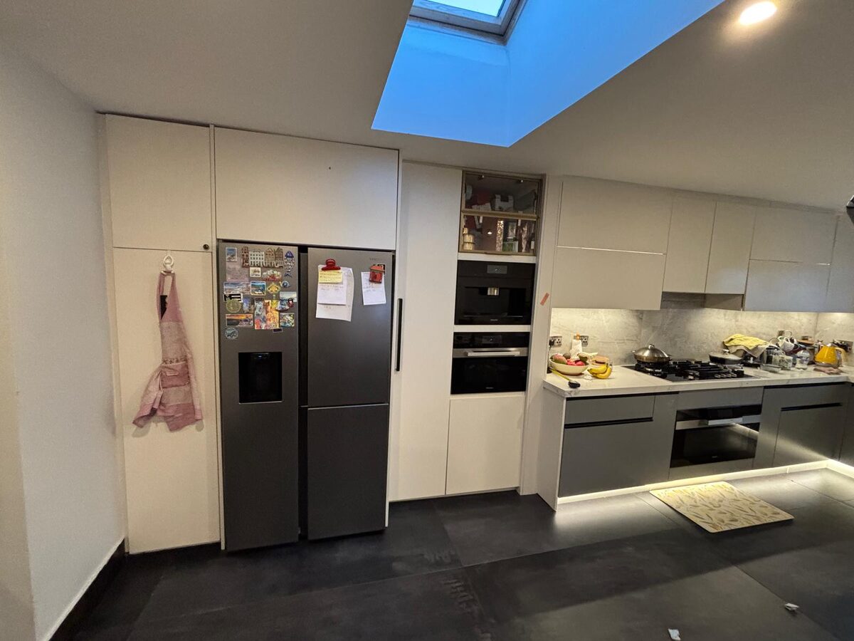 An American fridge housing under a skylight in a kitchen we designed and fitted in Dublin
