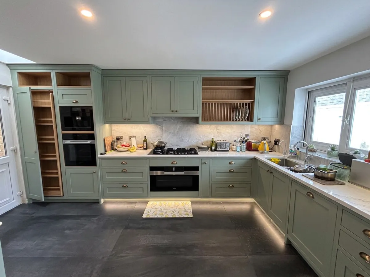 AI concept of the same kitchen in a sage green in frame style, not a real kitchen