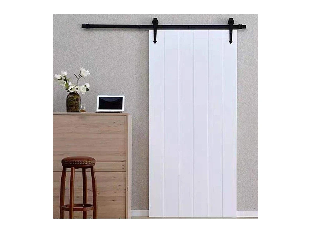 A white sliding door running on a black track fixed above the opening