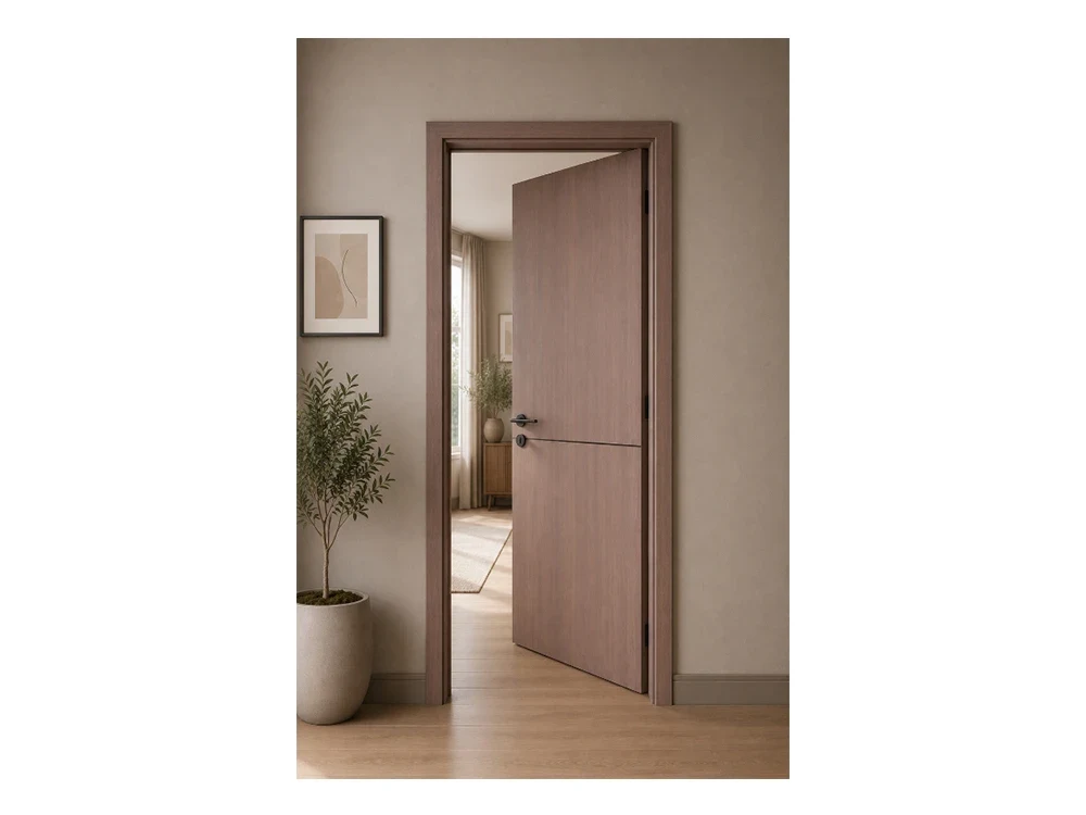A warm timber internal door standing open into a room beyond