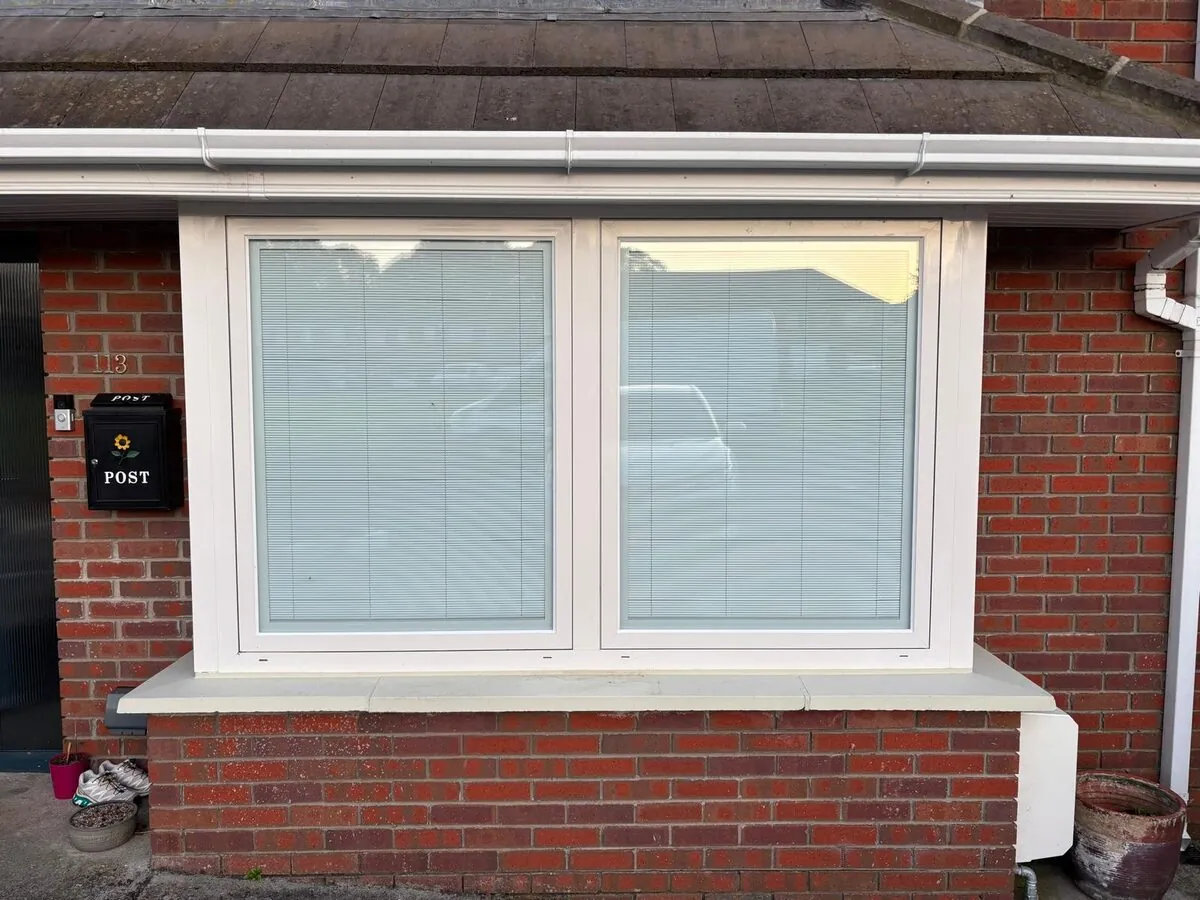 A new white window fitted in a red brick Dublin home, daylight