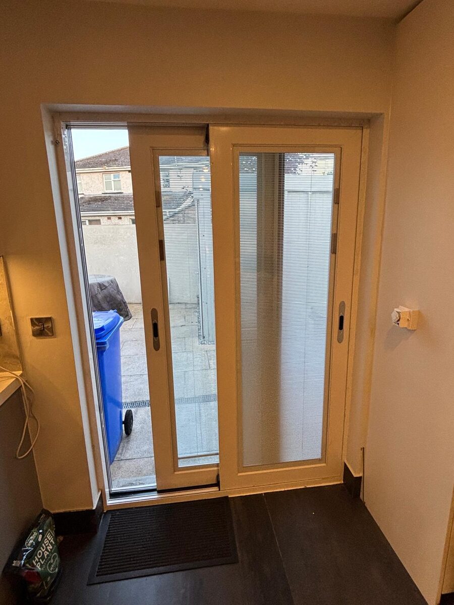 A patio door open to the garden in a Dublin home at dusk